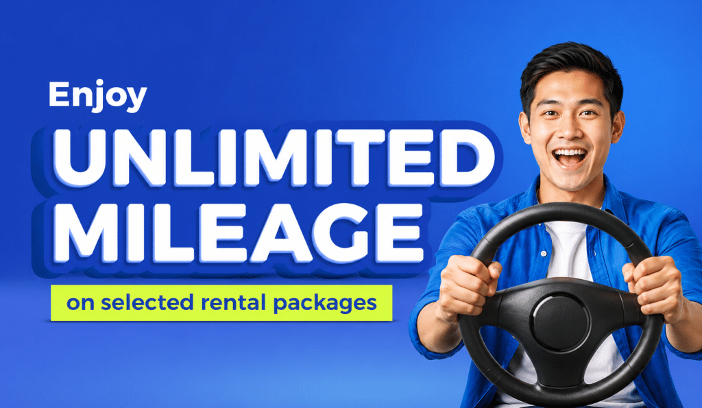Smiling young man holding a car steering wheel with bold 'UNLIMITED MILEAGE' text on a blue background and a yellow banner reading 'on selected rental packages'.